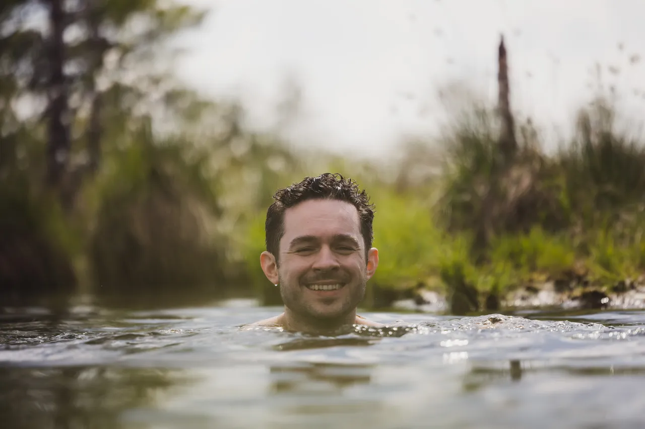 Man swimming in bog lake