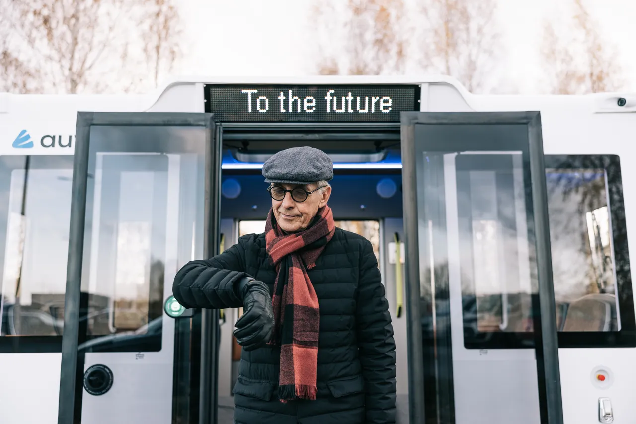 Man standing in front of self-driving bus