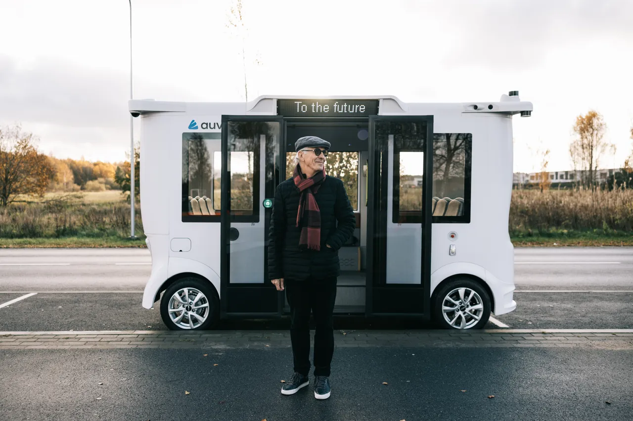 Man standing in front of self-driving bus
