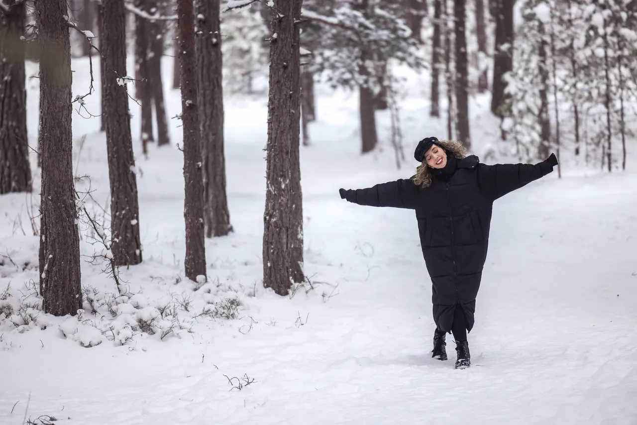 Woman in snowy forest