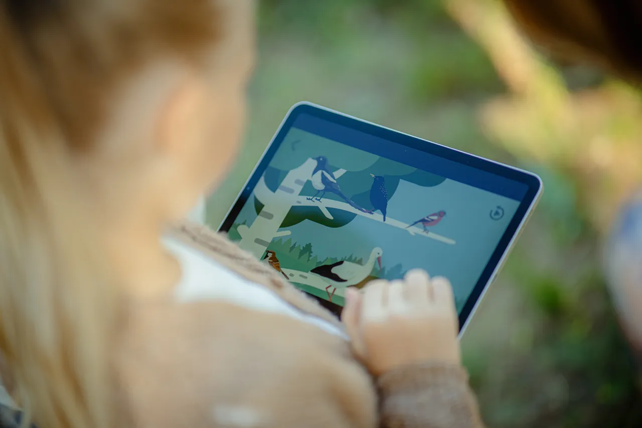 Child learning about nature on tablet