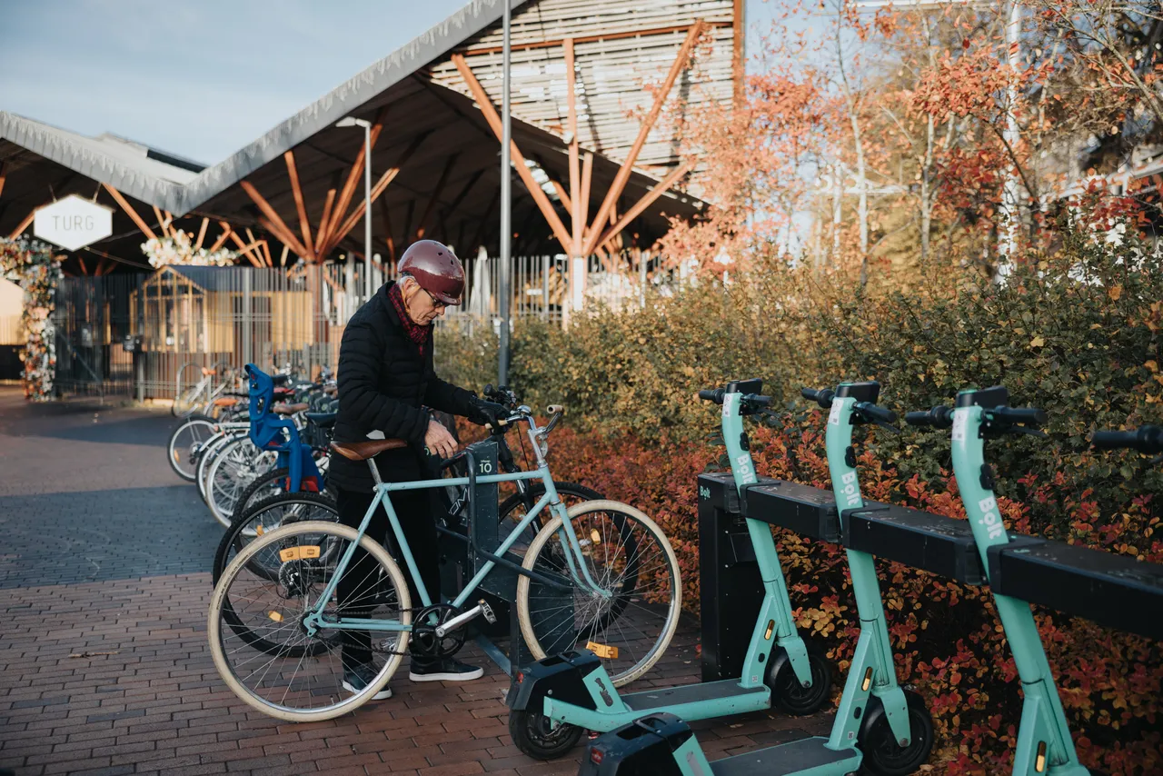 Man using a smart bike parking station