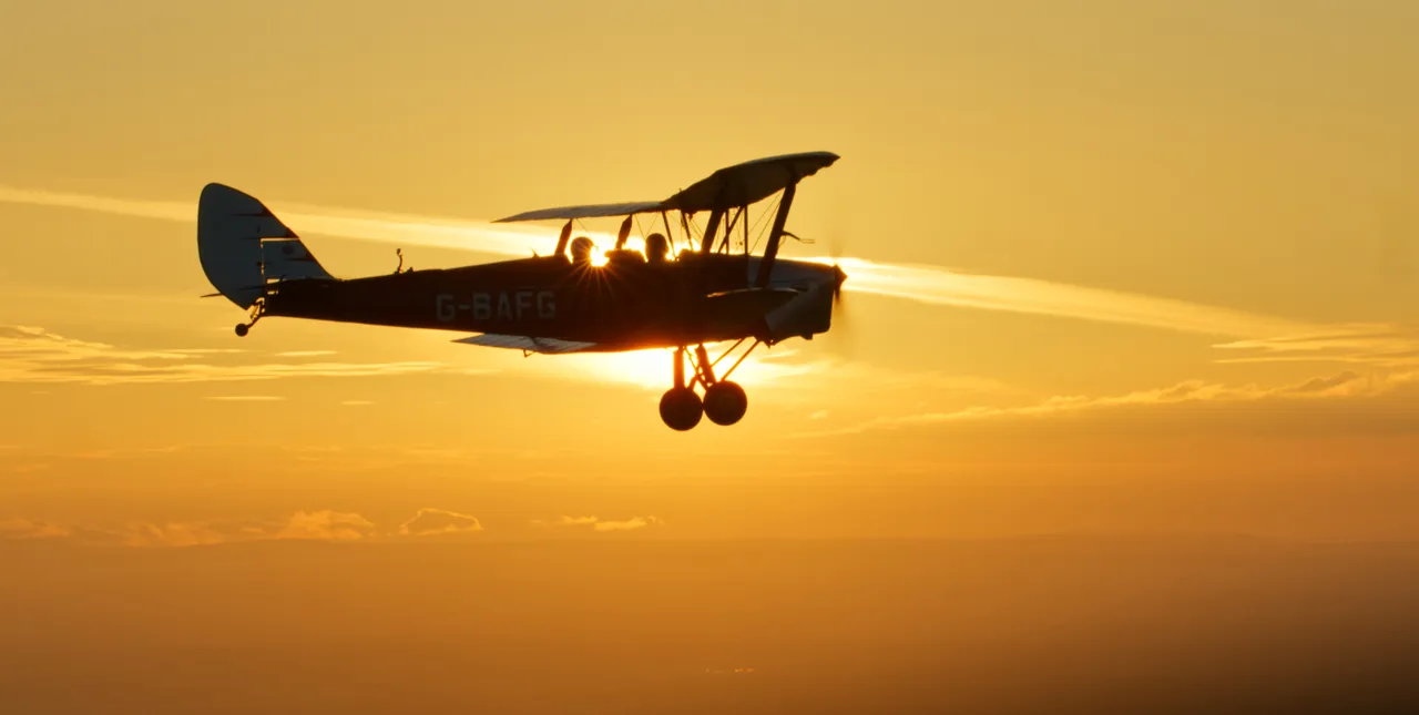 Tiger Moth fliying into sunset over Yorkshire © Project Yorkshire 2022